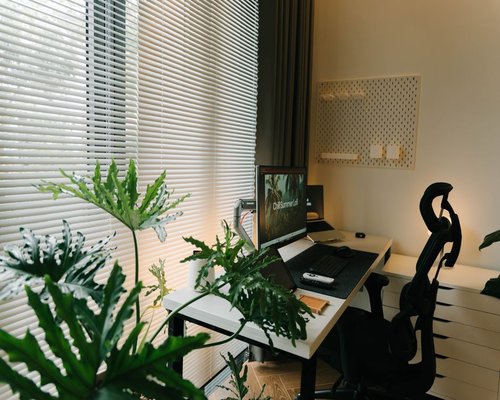 Clean and modern home office setup with soft natural light source from a side window in Monterrey